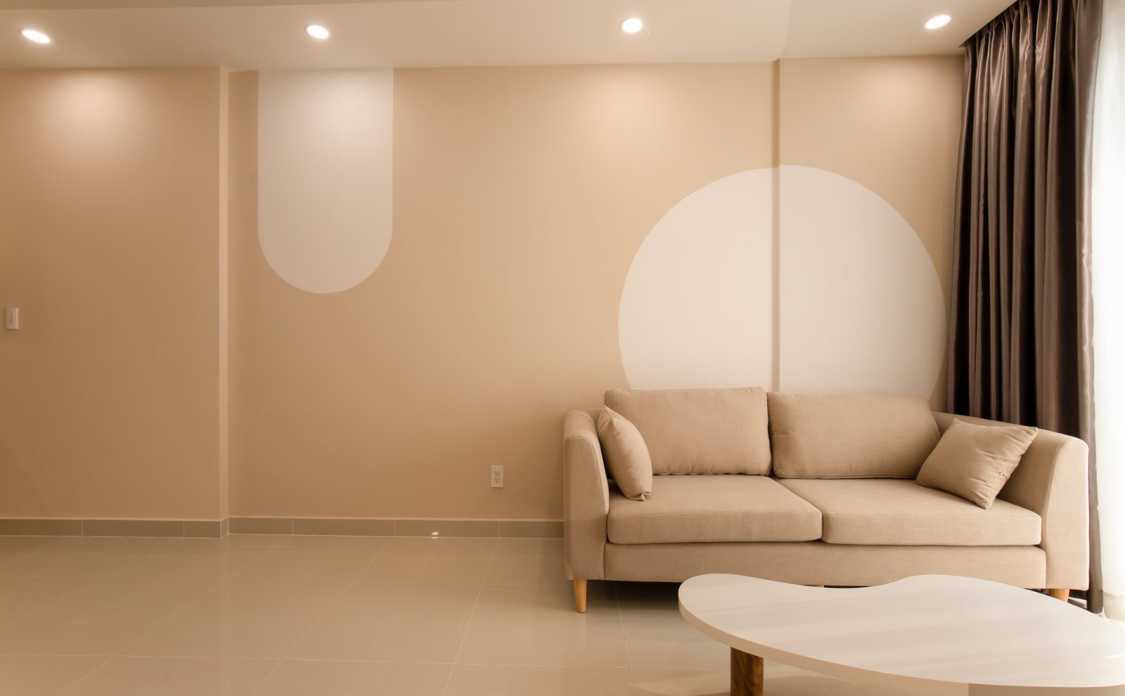 Calm living room with neutral sofa and warm wood furnishings