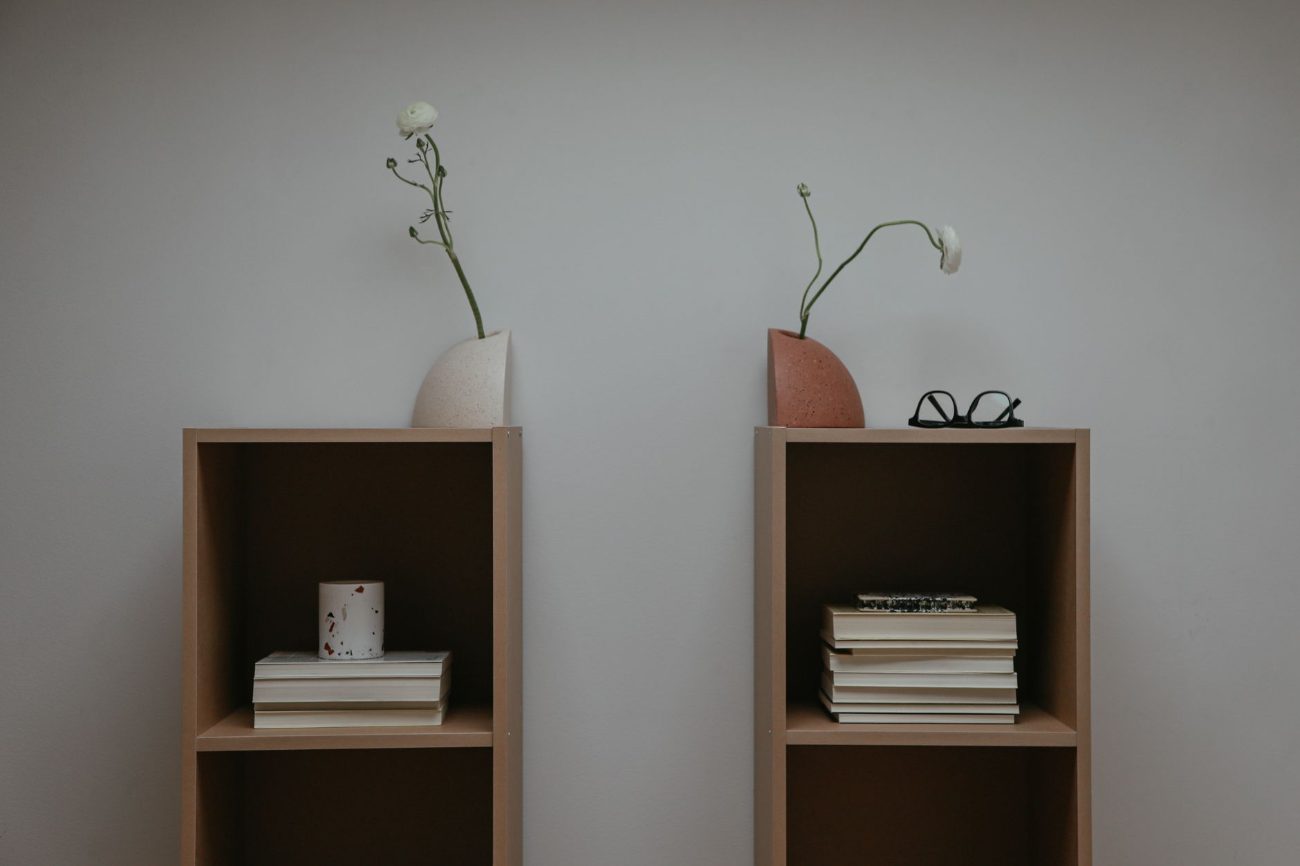 Styled bookshelf with art and warm decorative objects